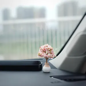 Elegant miniature cherry blossom tree ornament on a car dashboard for interior decoration