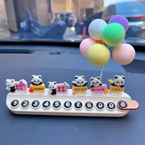 Close-up detail of cute panda car phone number plate with colorful balloon ornaments
