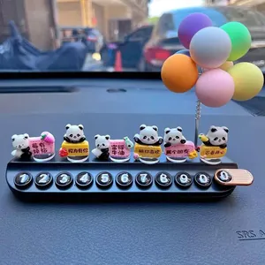 Close-up of cute panda temporary car parking card with colorful balloons on dashboard
