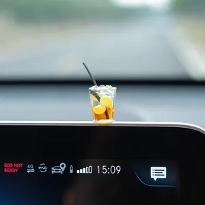 Miniature iced tea cup car ornament on dashboard screen for car interior decoration