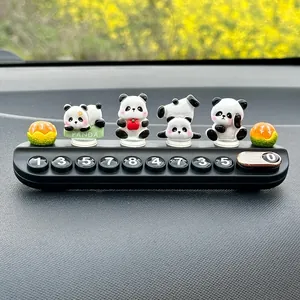 Detailed view of cute panda figurines on a car temporary parking phone number plate