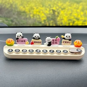 Close-up detail of cute panda car temporary parking phone number plate with fruit signs