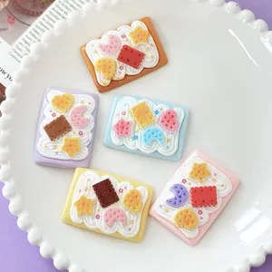 Close-up of cute star and moon cream biscuit resin charms on a white plate