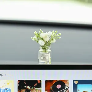 Macro detail of artificial white flowers in a small glass vase on a car dashboard