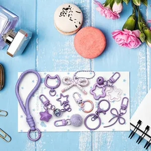 Detailed view of purple DIY keychain accessories set with various cute charms and clips