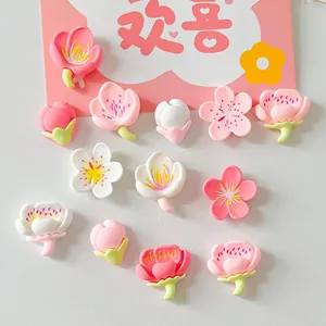 Close-up of resin cherry and peach blossom flower charms for DIY accessories