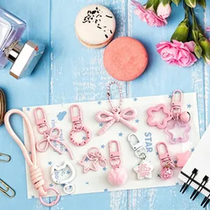 Detail view of assorted pink and white DIY keychain accessories and charms