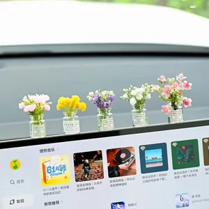 Detailed view of miniature car flower vases with colorful artificial flowers on dashboard