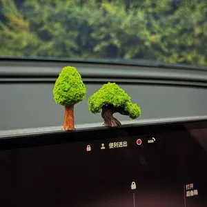Close-up detail of creative miniature bonsai ornaments for car dashboard interior decoration.