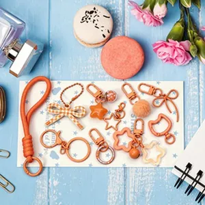 Detailed macro shot of various orange DIY keychain accessories and cute charms.