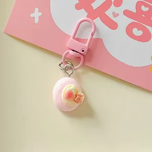 Close-up detail view of a cute pink strawberry miniature food keychain accessory