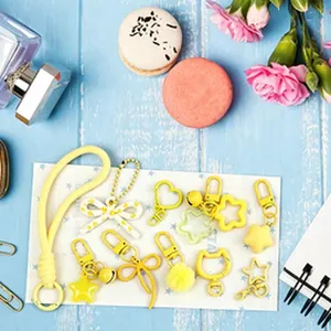Assorted yellow DIY keychain charms and accessories for cute personalized bag decoration
