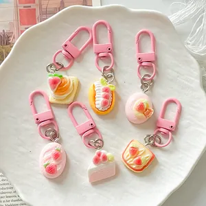 Detailed view of 6 cute pink dessert-themed simulation food keychains on a plate