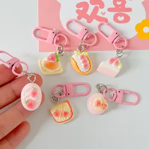 Collection of cute strawberry-themed mini food keychains for bags and mobile phones.