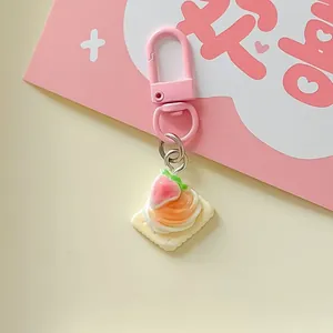 Macro view of a cute simulation strawberry cream biscuit charm on a pink keychain