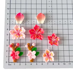 Set di magneti per frigorifero a forma di fiori di pesco 3D su sfondo a griglia grigia
