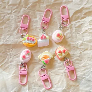 Set of six cute simulation strawberry dessert keychains on pink lobster clasps.
