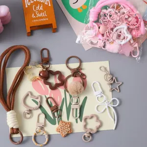 Collection of cute cartoon colorful DIY keychain charms and bag accessories in pastel colors.
