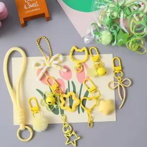 Assorted cute yellow DIY keychain accessories for bag decoration and handmade crafts