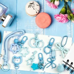Collection of cute light blue DIY keychain accessories with cartoon charms and bows
