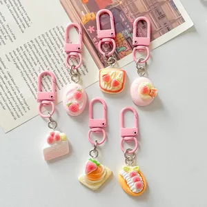 Close-up of assorted simulation strawberry dessert charms with pink lobster clasps