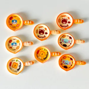 Detailed view of assorted cartoon frying pan resin charms with bread-shaped handles