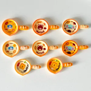 Detailed view of colorful cartoon frying pan resin accessories with animal motifs