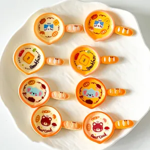 Detailed macro view of cute cartoon pan resin accessories featuring cat and bear designs