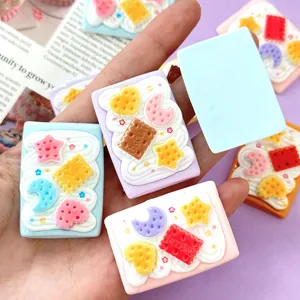 Macro view of cute resin biscuit charms with stars and moons for DIY hair clip crafts.
