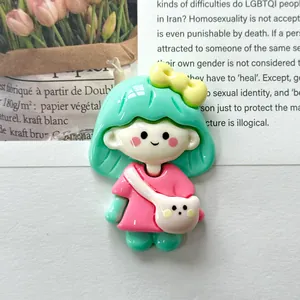 Macro view of a cute shiny resin girl charm with mint hair and bear backpack for DIY craft