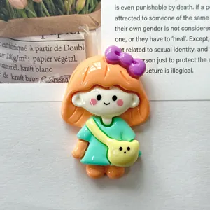 Close-up of a glossy cute cartoon girl resin cabochon with a yellow bag for DIY crafts