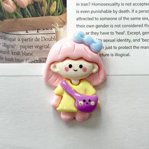 Detailed macro view of a cute cartoon girl resin charm for DIY phone case decoration