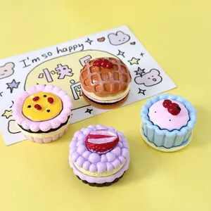 Macro view of colorful miniature simulation cream cakes and waffles for DIY crafts
