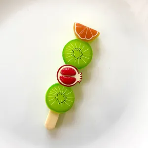 Detailed macro view of colorful fruit skewer resin charms for DIY craft making projects