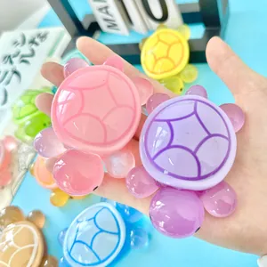 Handheld large glow-in-the-dark resin turtle figurines in various vibrant candy colors