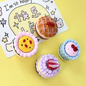 Close-up of colorful miniature resin cakes and waffles for DIY crafts and dollhouses.