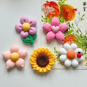 Detailed view of colorful resin five-petal flowers and a sunflower DIY accessory