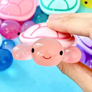 Detailed close-up of a cute pink luminous resin turtle figurine with jelly texture