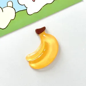 Vista detallada de un amuleto de resina de plátano amarillo translúcido para decoración DIY