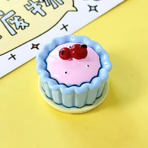 Close-up macro view of a miniature blue and pink cupcake dessert toy food model