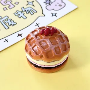 Macro view of miniature strawberry waffle toy model with realistic cream textures