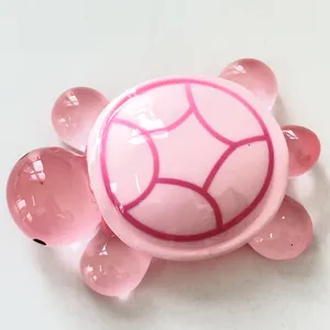 Macro detail view of a pink night-glow resin turtle figurine with transparent limbs.