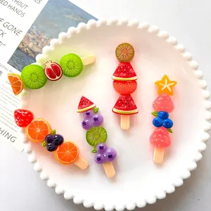 Detailed macro close-up of vibrant fruit-shaped resin skewer accessories on a white plate