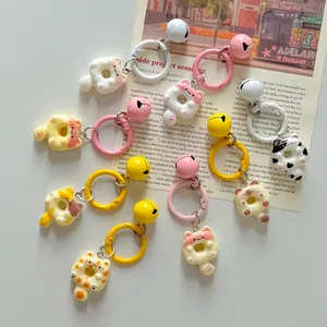 Adorably designed cartoon donut cat keychains featuring colorful rings and bells