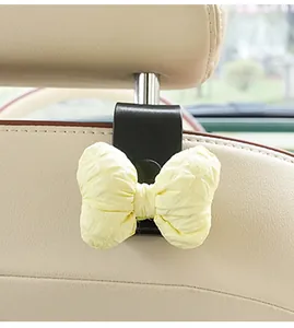 Close-up of a cute car seat back hook with a soft yellow quilted fabric bow detail
