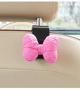 Detail of car seat back hook with a cute pink bubble fabric bow decoration for car storage