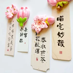 Detail view of decorative pink peach blossom flower fridge magnets on paper cards