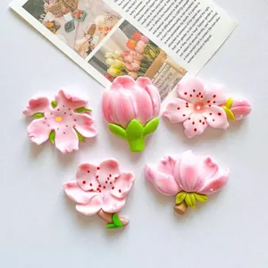 Detail view of 5 different styles of pink peach blossom floral refrigerator magnets