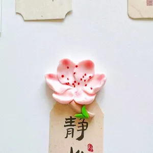 Detailed macro view of a pink cherry blossom fridge magnet with a creative floral design