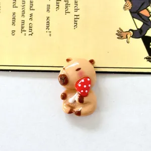 Macro view of a cute resin capybara figurine holding a red mushroom for DIY shoe charms